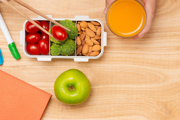 Healthy lunch box with sandwich and fresh vegetables, bottle of water. Healthy eating concept. Top view - Photo, Image