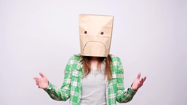 Woman in sad ecological paper bag on head - Footage, Video