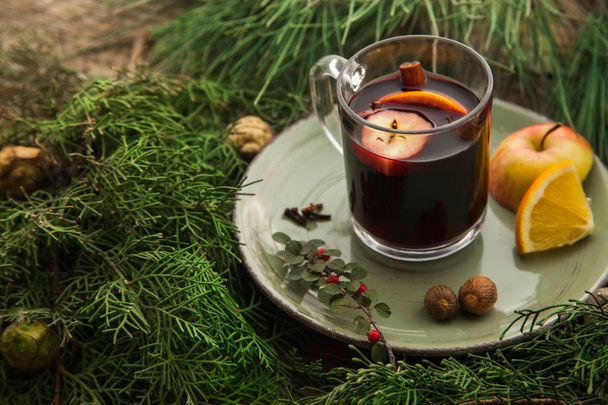 Hot mulled wine in a cup with ingredients to cook on plate. - Photo, Image