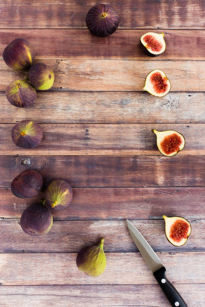 Whole and Halved Figs on Brown Wood Background - Photo, Image