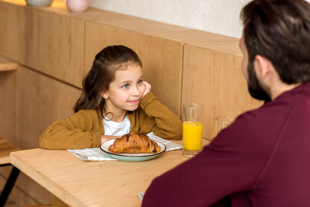 bijgesneden afbeelding van dochter kijken naar vader zittend in café - Foto, afbeelding