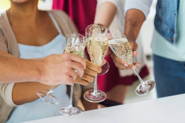 friends clinking glasses of champagne at party - 写真・画像