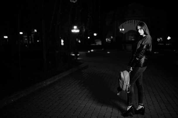 Night portrait of girl model wear on glasses, jeans and leather  - Photo, image