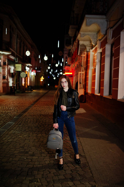 Night portrait of girl model wear on glasses, jeans and leather  - Photo, Image