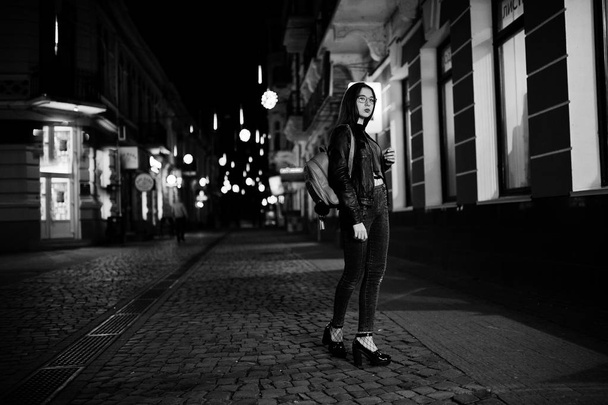 Night portrait of girl model wear on glasses, jeans and leather  - Foto, Imagem