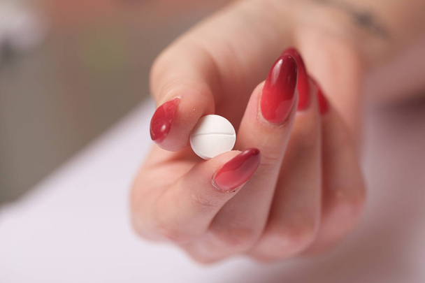close up of a woman showing pill - Фото, зображення