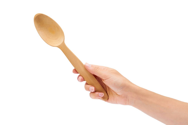 wooden spoon in hand isolated on white background - Foto, afbeelding