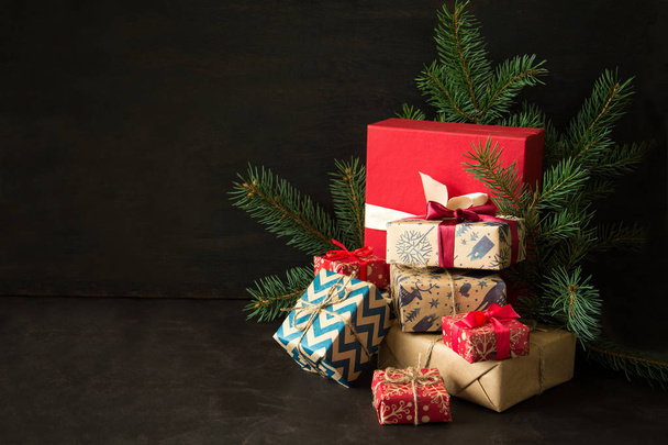 Christmas gift boxes on dark wooden desk. - Photo, Image