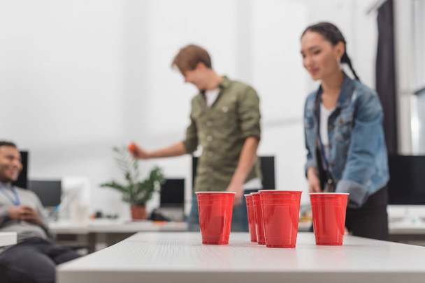 young workers playing beer pong at modern office after work - Zdjęcie, obraz