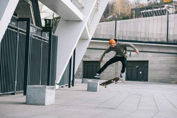 skateboarder performing jump trick in urban location - Photo, image