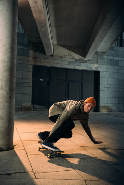 handsome young man riding skateboard - Valokuva, kuva