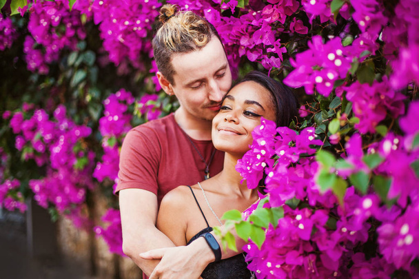 young couple Kissing  near blooming tree - Foto, afbeelding