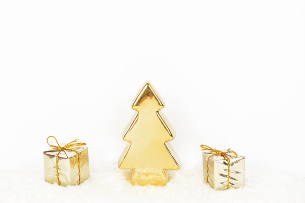 Christmas background with gold christmas tree and gifts on glitt - 写真・画像