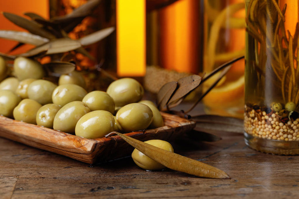 Green olives and bottles of olive oil . - Photo, Image