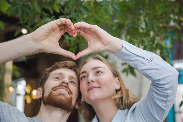 Content couple making heart with hands - Photo, Image