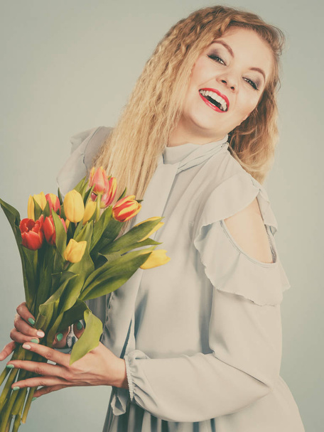Pretty woman with red yellow tulips bunch - Foto, Imagem