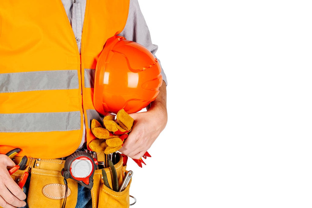 torso engineer or worker hand holding orange helmet for workers. - Foto, Imagem