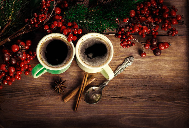 Cups of fragrant coffee with fir tre branches, aroma spices and berries, copy space - Foto, imagen