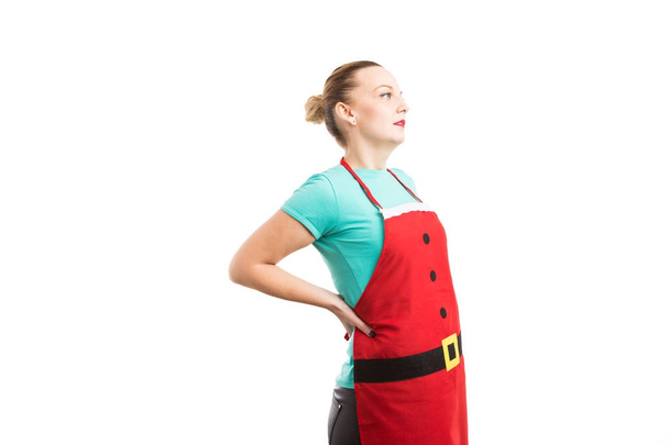 Concepto de dolor lumbar con mujer usando delantal de Navidad
 - Foto, Imagen