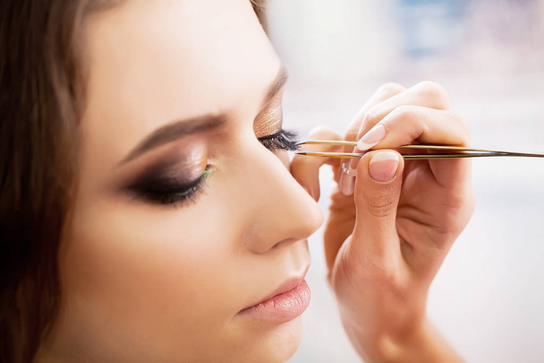 young, beautiful girl put on make-up in a beauty salon - Photo, Image