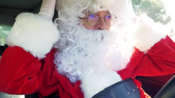 Lustige Weihnachtsmann setzen Hut während der Autofahrt Nahaufnahme Zeitlupe - Filmmaterial, Video