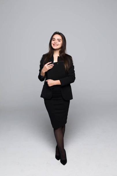Full body portrait of professional business woman with blanck standing on gray background - Fotografie, Obrázek