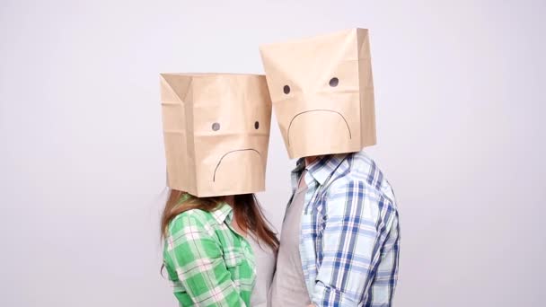 A couple with sad faces with paper bags on their heads - Footage, Video