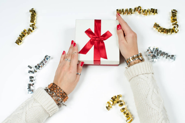 Woman wearing bracelet, Christmas gift on a wooden table background - Zdjęcie, obraz