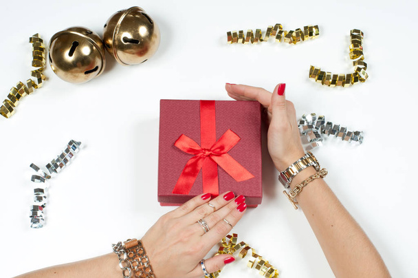 Woman wearing bracelet, Christmas gift on a wooden table background - Φωτογραφία, εικόνα