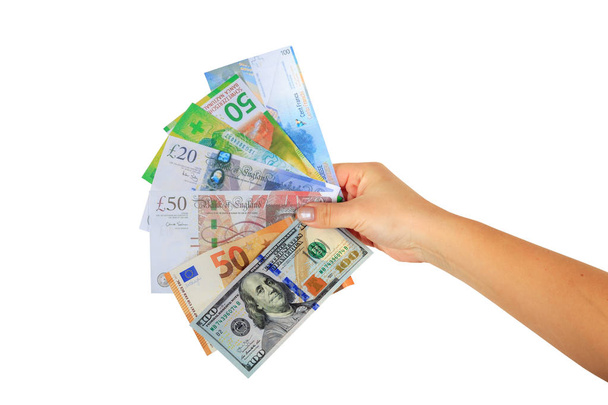 vrouwelijke hand die papier bankbiljetten dollar, Euro, Zwitserse franc en Britse pond - Foto, afbeelding