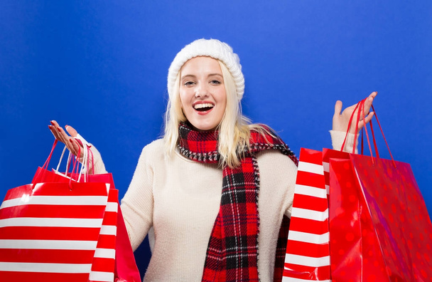 Happy young woman holding shopping bags  - Foto, Imagen