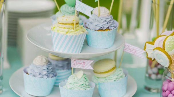 Λεπτομέρειες σχετικά με ένα νόστιμο γλύκισμα με κανάτες από γλυκά, μπισκότα και ζαχαρωτά, γλυκά, βάφλες, μπισκότα και macaroons, γλυκά αντίληψη για τα γενέθλια των παιδιών - Φωτογραφία, εικόνα