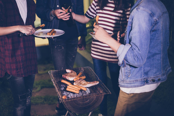 Asian group of friends having outdoor garden barbecue laughing w - Photo, Image