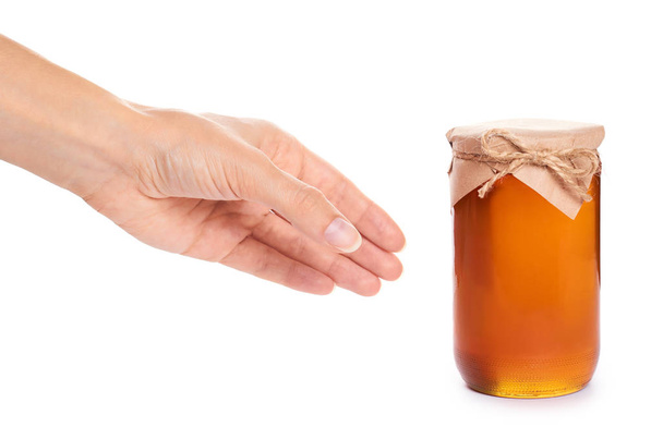 eco home made honey in jar in hand isolated on white background - Foto, afbeelding