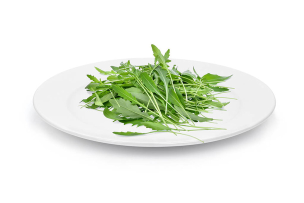 green wild rocket leaves in the white plate isolated on white ba - Foto, Bild