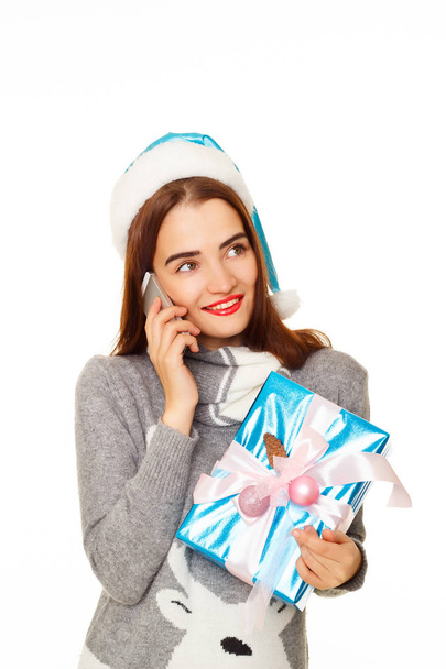 Young Happy woman in  warm sweater talking by mobile over white  - Foto, afbeelding