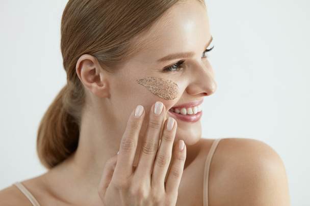 Face Skin Scrub. Smiling Female Applying Scrub On Face Skin - 写真・画像