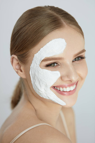 Face Mask. Portrait Of Beautiful Woman With White Facial Mask - Фото, изображение