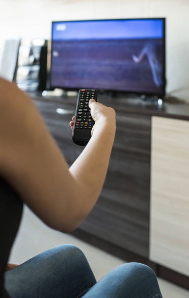 Woman hold TV remote control.  - Photo, image