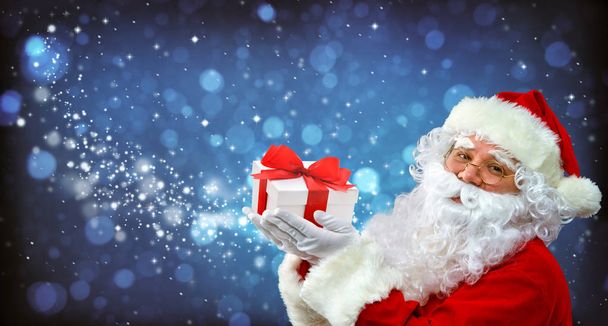 Santa Claus with magic light in his hands - Фото, изображение