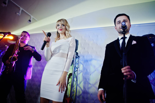 Musicial music live band performing on a stage with different li - Фото, изображение
