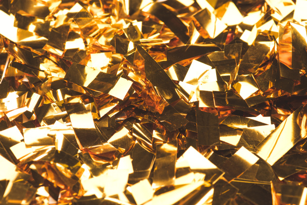 close up view of sparking golden confetti - Foto, Imagen