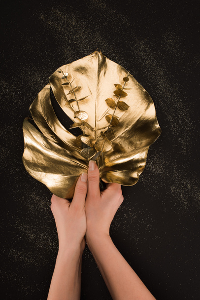 partial view of female hands holding different golden plants - Foto, immagini