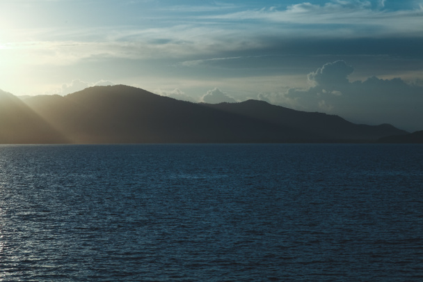 beautiful seascape with hills silhouette on evening - Fotó, kép