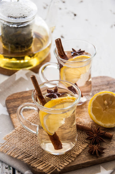 Hot christmas tea with spices - cinnamon  and star anise on a light wooden background  - Foto, Imagen