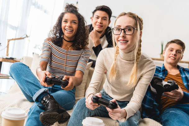 happy teenage multiethnic girls playing video game - Фото, изображение