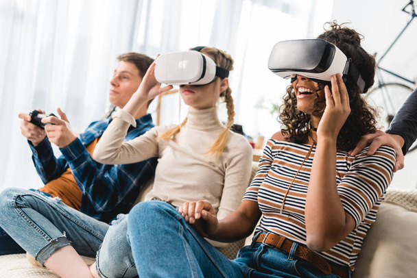 multiethnic teen girls watching something with virtual reality headsets  - Photo, Image