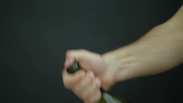 Champagne explosion. Man hand opening champagne bottle closeup. Sparkling Wine over Holiday Bokeh Blinking Background. Champagne bottle closeup. Success celebrating. Slow motion - Кадри, відео