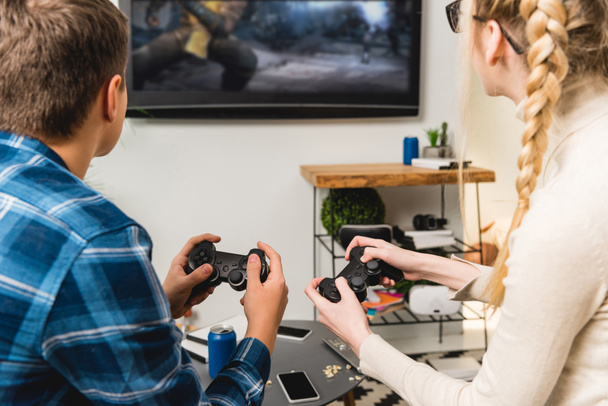 back view of two teens playing video game - Photo, Image