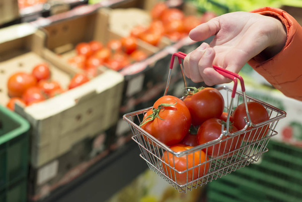 Buying tomatoes in shop. - Фото, изображение